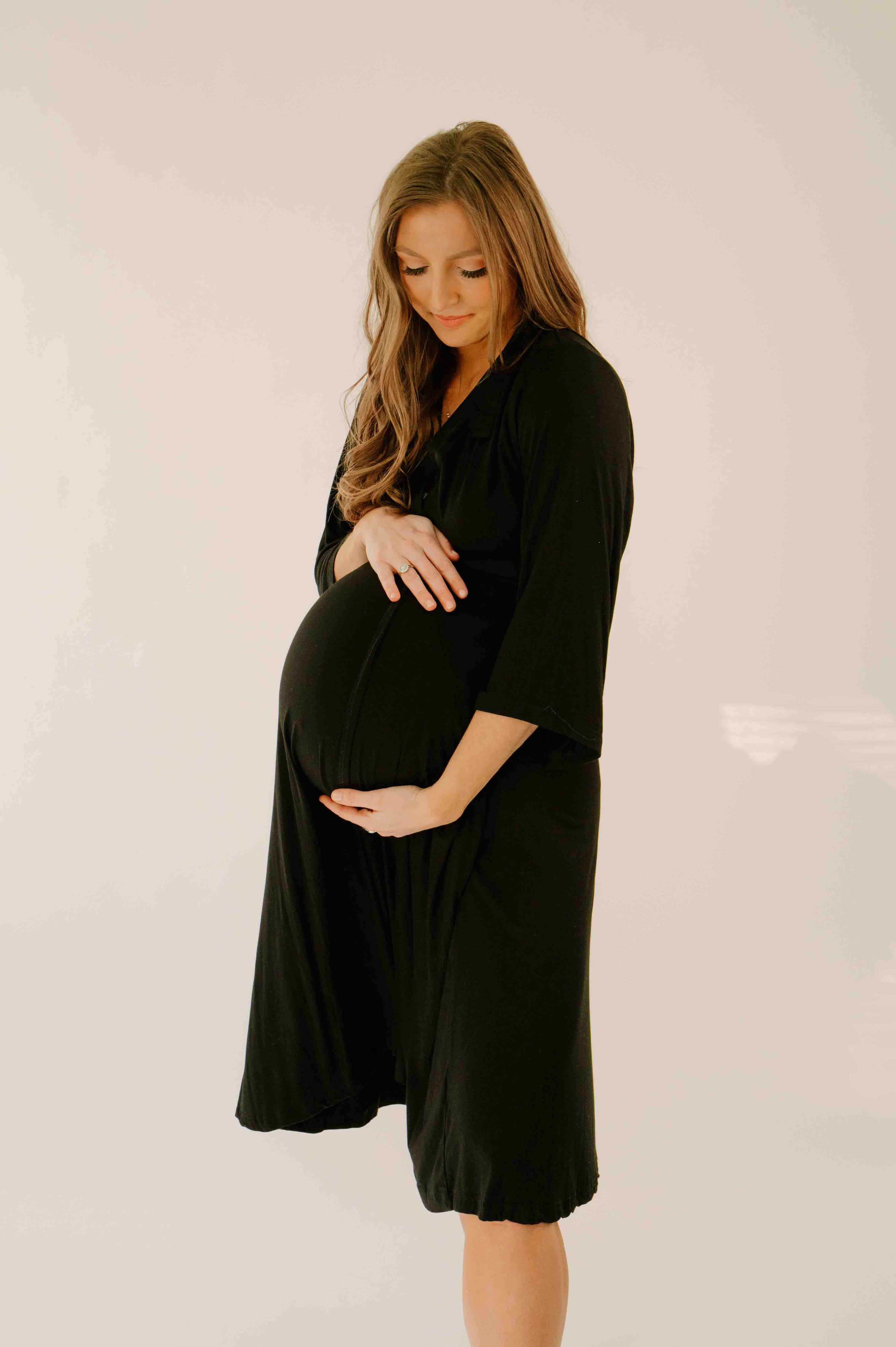 woman standing in black labor and delivery gown